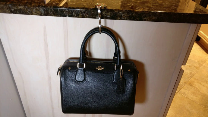 A purse hook is a fantastic little piece to always carry around, in case you're in a dirty bar or restaurant, and you don't want to put your bag on the sticky chairs or ...