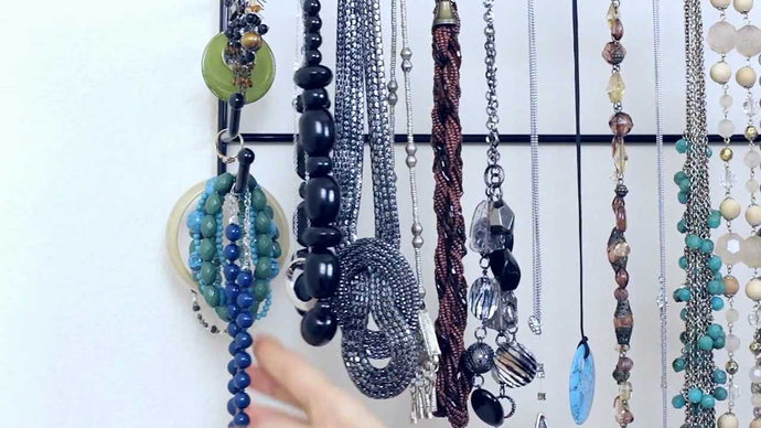 Try hanging your necklaces on "S" hooks (found at your local hardware store) on the front necklace bar of your Belledangles for fast access